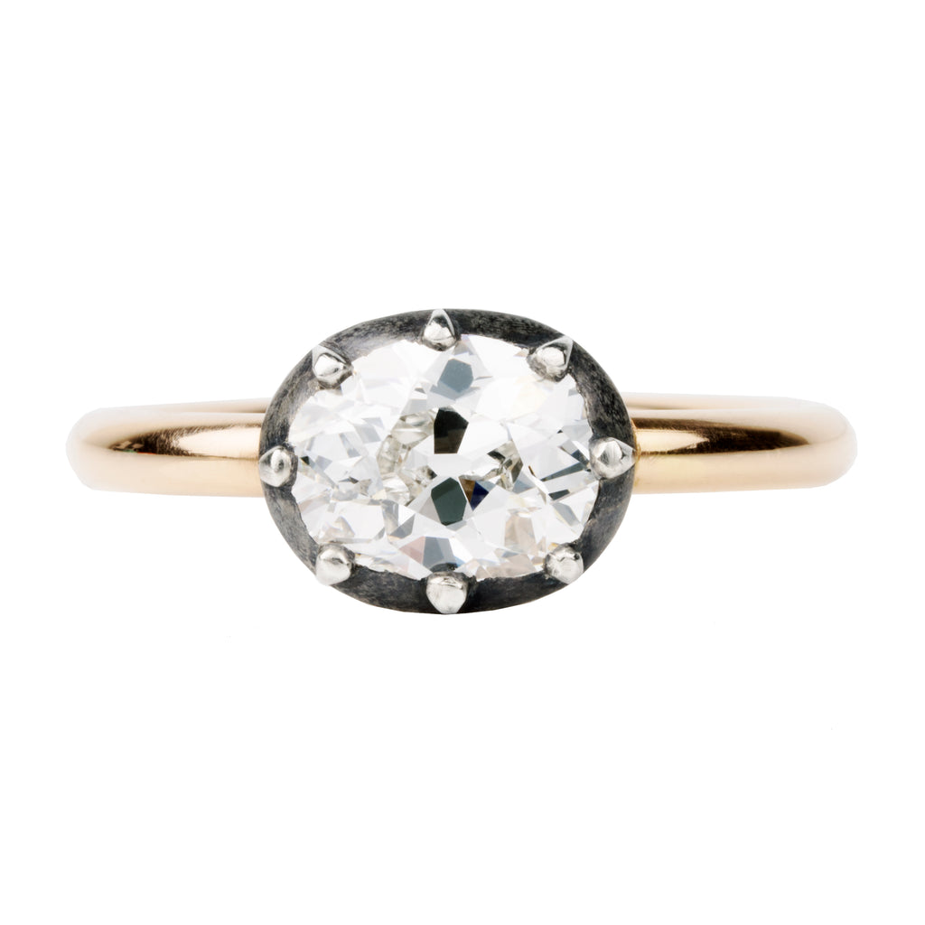 One of our signature designs, in silver-topped 18k gold. This design s inspired by a labor-intensive setting technique common in 18th and 19th-century rings. The silver-on-gold technique is true to the rings that inspired this design and is rarely seen in modern jewelry. This features a GIA certified cushion cut diamond 1.43 carat, I color and VS2 clarity. Front view. 