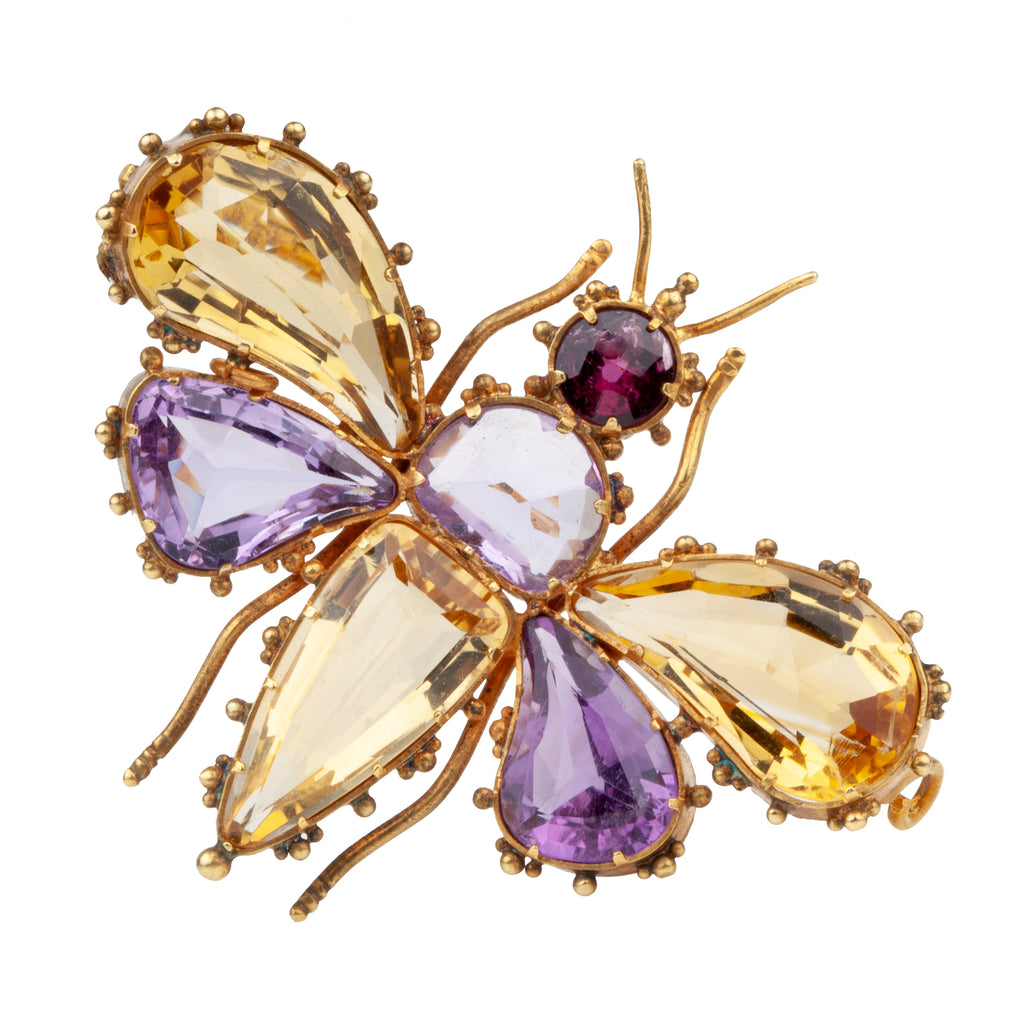 Finely made early Victorian citrine, amethyst and garnet butterfly brooch, set in gold. Beautiful combination of contrasting amethyst and citrine wings. In Etruscan revival motif. English in origin. Circa 1850. Close-up view. 